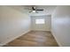 Clean bedroom featuring light wood flooring, a window, and neutral walls at 1263 W Devonshire St, Mesa, AZ 85201