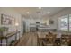 Open-concept kitchen and dining area with wood floors and large windows for natural light at 1263 W Devonshire St, Mesa, AZ 85201