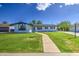 Charming single-story home with lush green lawn, walkway, and freshly painted exterior for great curb appeal at 1263 W Devonshire St, Mesa, AZ 85201
