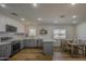 Bright, open kitchen with stainless appliances, an island, and a dining table with seating at 1263 W Devonshire St, Mesa, AZ 85201