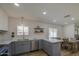 Open kitchen design featuring a stainless steel dishwasher, sink, stylish faucet, and white subway tile at 1263 W Devonshire St, Mesa, AZ 85201