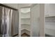 Walk-in pantry with frosted glass door and ample shelving offers plenty of storage space at 1263 W Devonshire St, Mesa, AZ 85201