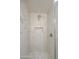 Shower featuring white tile, rainfall shower head, built-in niche, glass door, and hexagon tile floor at 1263 W Devonshire St, Mesa, AZ 85201