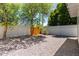 Backyard featuring large shade trees, a wood fence and a rock garden for easy maintenance at 1313 N 71St St, Scottsdale, AZ 85257
