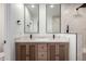 Bathroom featuring dual sinks, quartz countertops, modern tile, and walk-in shower at 1313 N 71St St, Scottsdale, AZ 85257