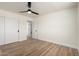 Bedroom featuring wood-look floors, modern fan, and large closet at 1313 N 71St St, Scottsdale, AZ 85257