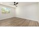 Bright bedroom featuring wood-look flooring, white walls, and large window at 1313 N 71St St, Scottsdale, AZ 85257