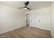 Bedroom with wood-look floors, fan, closet with sliding doors, and a bright airy atmosphere at 1313 N 71St St, Scottsdale, AZ 85257