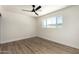 Bright bedroom featuring wood-look floors, a ceiling fan, and a window bringing in sunlight at 1313 N 71St St, Scottsdale, AZ 85257
