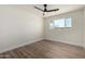 Bright bedroom featuring wood-look floors, ceiling fan, and a window offering plenty of natural light at 1313 N 71St St, Scottsdale, AZ 85257