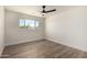 Bedroom featuring wood floors, a ceiling fan, a window and white walls at 1313 N 71St St, Scottsdale, AZ 85257