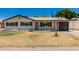 Charming home with neutral paint, dark shutters, covered front entrance, and a drought-resistant front yard at 1313 N 71St St, Scottsdale, AZ 85257