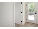 Hallway featuring wood-look flooring, white trim, and an exterior door with glass at 1313 N 71St St, Scottsdale, AZ 85257