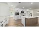 Modern kitchen with stainless steel appliances, white cabinets, marble counters and wood paneled island at 1313 N 71St St, Scottsdale, AZ 85257