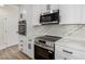 Updated kitchen featuring stainless steel oven, microwave, and white marbled countertops at 1313 N 71St St, Scottsdale, AZ 85257