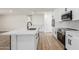 Bright kitchen showcasing white cabinets, quartz countertops, and stainless steel appliances at 1313 N 71St St, Scottsdale, AZ 85257
