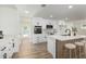 Modern white kitchen boasts stainless steel appliances, a marble backsplash, and a stylish kitchen island at 1313 N 71St St, Scottsdale, AZ 85257