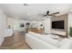 Open concept living area with a large white sofa, modern ceiling fan, and a view of the kitchen at 1313 N 71St St, Scottsdale, AZ 85257