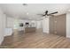 Open-concept living room featuring wood floors and a decorative wood paneled wall and ceiling fan at 1313 N 71St St, Scottsdale, AZ 85257