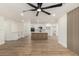 Spacious living room with wood floors, ceiling fan, and updated kitchen in the background at 1313 N 71St St, Scottsdale, AZ 85257