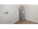 Utility room area with wood-look floors, and newer hot water heater installed at 1313 N 71St St, Scottsdale, AZ 85257