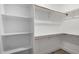 Spacious walk-in closet with white shelving, and a wood closet rod to keep your clothes organized at 1313 N 71St St, Scottsdale, AZ 85257