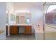 Bathroom featuring double sinks, vanity, soaking tub, and walk-in shower at 1463 W Mead Dr, Chandler, AZ 85248
