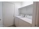 A laundry room with white appliances and shelving at 1463 W Mead Dr, Chandler, AZ 85248