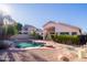 A backyard pool with rock features and desert landscaping with house in the background at 1463 W Mead Dr, Chandler, AZ 85248