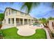 Large two-story home features a private backyard with pool, spa, grassy areas, and lush landscaping at 14823 W Windsor Ave, Goodyear, AZ 85395