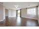 Spacious bedroom features hardwood floors, neutral paint, a window, and a door to a balcony at 14823 W Windsor Ave, Goodyear, AZ 85395