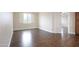Spacious bedroom features hardwood floors, neutral walls, baseboard trim, and a window at 14823 W Windsor Ave, Goodyear, AZ 85395