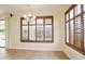 Bright dining room features tiled floors, plantation shutters, and sliding glass door at 14823 W Windsor Ave, Goodyear, AZ 85395