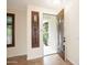 Inviting entryway featuring a decorative door, a window with shutters, and tiled floors creating an elegant first impression at 14823 W Windsor Ave, Goodyear, AZ 85395