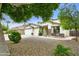 Charming curb appeal with desert landscaping, a seating area, and a well-maintained lawn, offering a warm welcome at 14823 W Windsor Ave, Goodyear, AZ 85395
