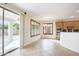 Open concept living and kitchen area with tile flooring and outdoor views at 14823 W Windsor Ave, Goodyear, AZ 85395