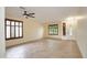 Bright living room with tiled floor, shuttered windows, and a ceiling fan, creating a comfortable and stylish space at 14823 W Windsor Ave, Goodyear, AZ 85395
