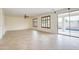 Spacious living room with tile flooring, ceiling fan and a sliding glass door at 14823 W Windsor Ave, Goodyear, AZ 85395