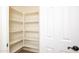 Walk-in pantry provides ample storage with bright shelving at 14823 W Windsor Ave, Goodyear, AZ 85395