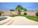 Backyard pool and patio area, enhanced by palm trees and a well maintained block wall at 14823 W Windsor Ave, Goodyear, AZ 85395