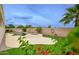 Outdoor space featuring a refreshing pool and spa with lush greenery and colorful flowers in backyard at 14823 W Windsor Ave, Goodyear, AZ 85395