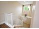 Bright stairway features a white railing, beige walls, and a window providing natural light at 14823 W Windsor Ave, Goodyear, AZ 85395