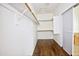 Spacious walk-in closet features custom wood flooring, ample shelving and easy access to the bathroom with sliding door at 14823 W Windsor Ave, Goodyear, AZ 85395
