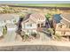 Aerial view of a beautiful two-story home showcasing the tile roof, desert landscape, and proximity to green fields at 17009 S Coleman St, Phoenix, AZ 85045