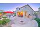 Spacious backyard with desert landscaping, outdoor seating, a fire pit, BBQ grill, and a basketball hoop at 17009 S Coleman St, Phoenix, AZ 85045