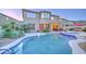 Desert landscaped backyard with a sparkling pool, a hot tub, outdoor seating, and BBQ grill at 17009 S Coleman St, Phoenix, AZ 85045