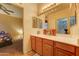 Bathroom features a wooden vanity with a white countertop and a baseball-themed decor at 17009 S Coleman St, Phoenix, AZ 85045