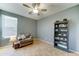 Comfortable bedroom with a ceiling fan, chair, and bookshelf at 17009 S Coleman St, Phoenix, AZ 85045