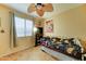 Cozy bedroom with a window, fan, book shelf, and vintage-style bed frame at 17009 S Coleman St, Phoenix, AZ 85045