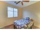 Bright bedroom with a cozy bed, carpeted floor, and a ceiling fan at 17009 S Coleman St, Phoenix, AZ 85045